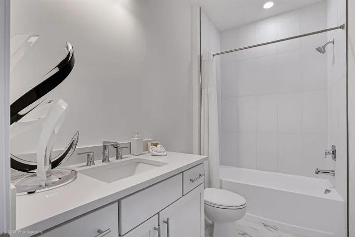 Secondary bath with upgraded finishes, including quartz vanity top