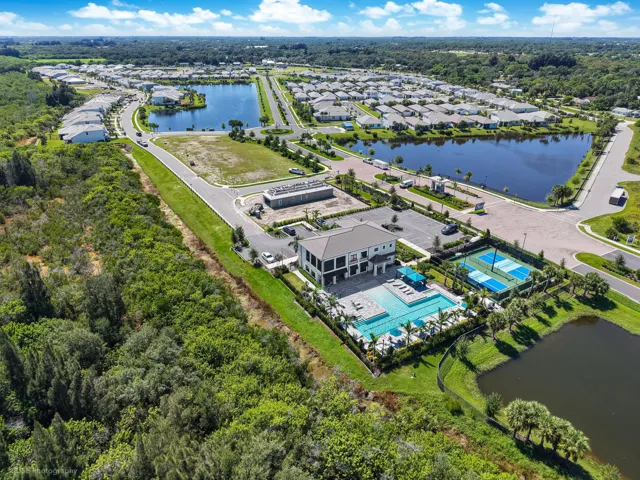 Community amenities featuring a clubhouse, beach entry pool, and multiple tennis/pickle ball courts