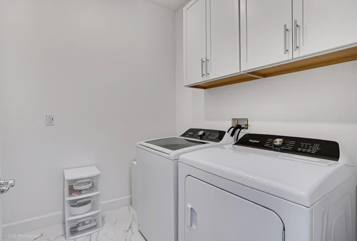 Laundry room with additional cabinets for storage and a laundry sink