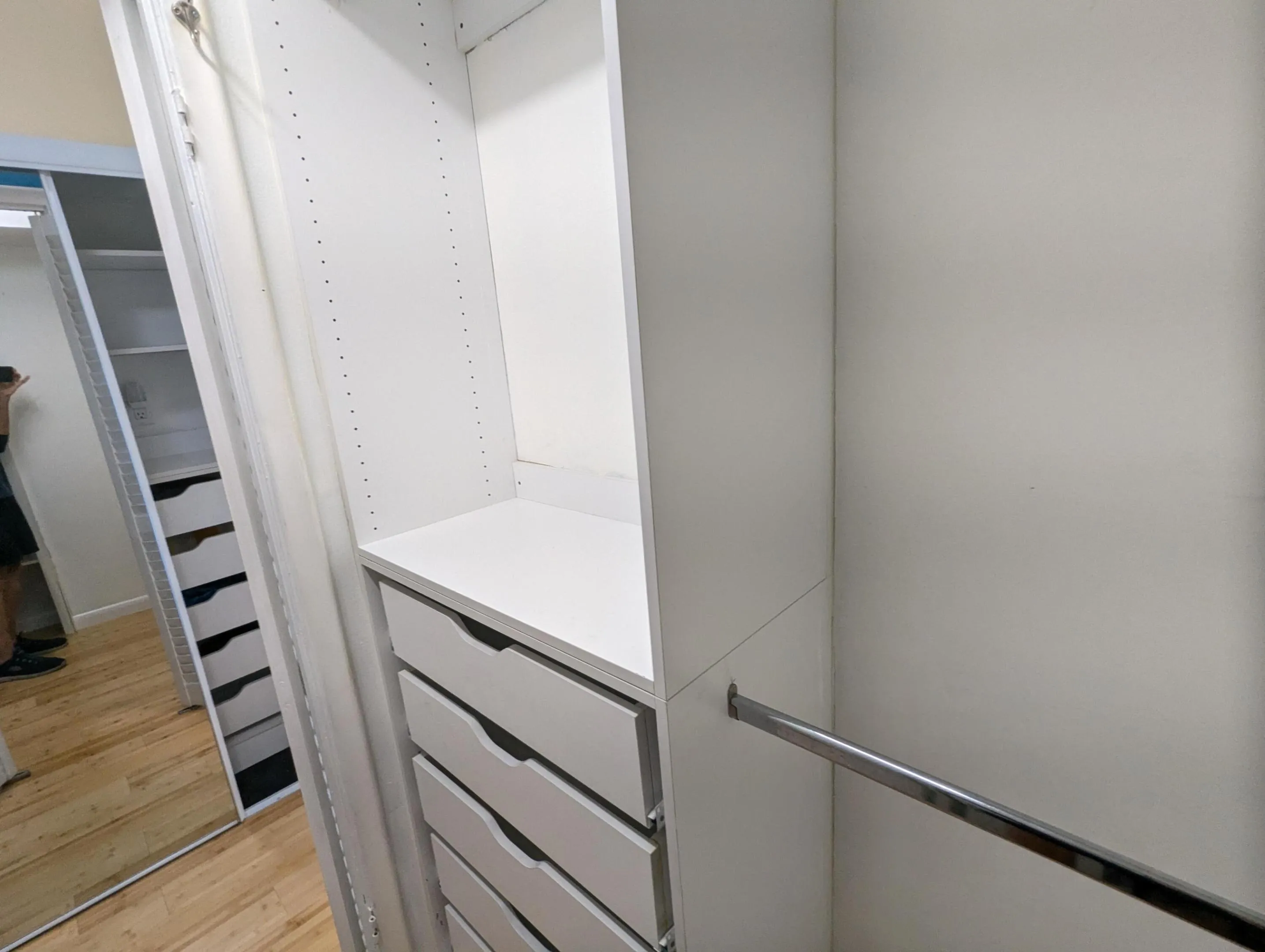 Walk in closet! Built-in system featuring multiple drawers, adjustable shelving, and a chrome hanging rod