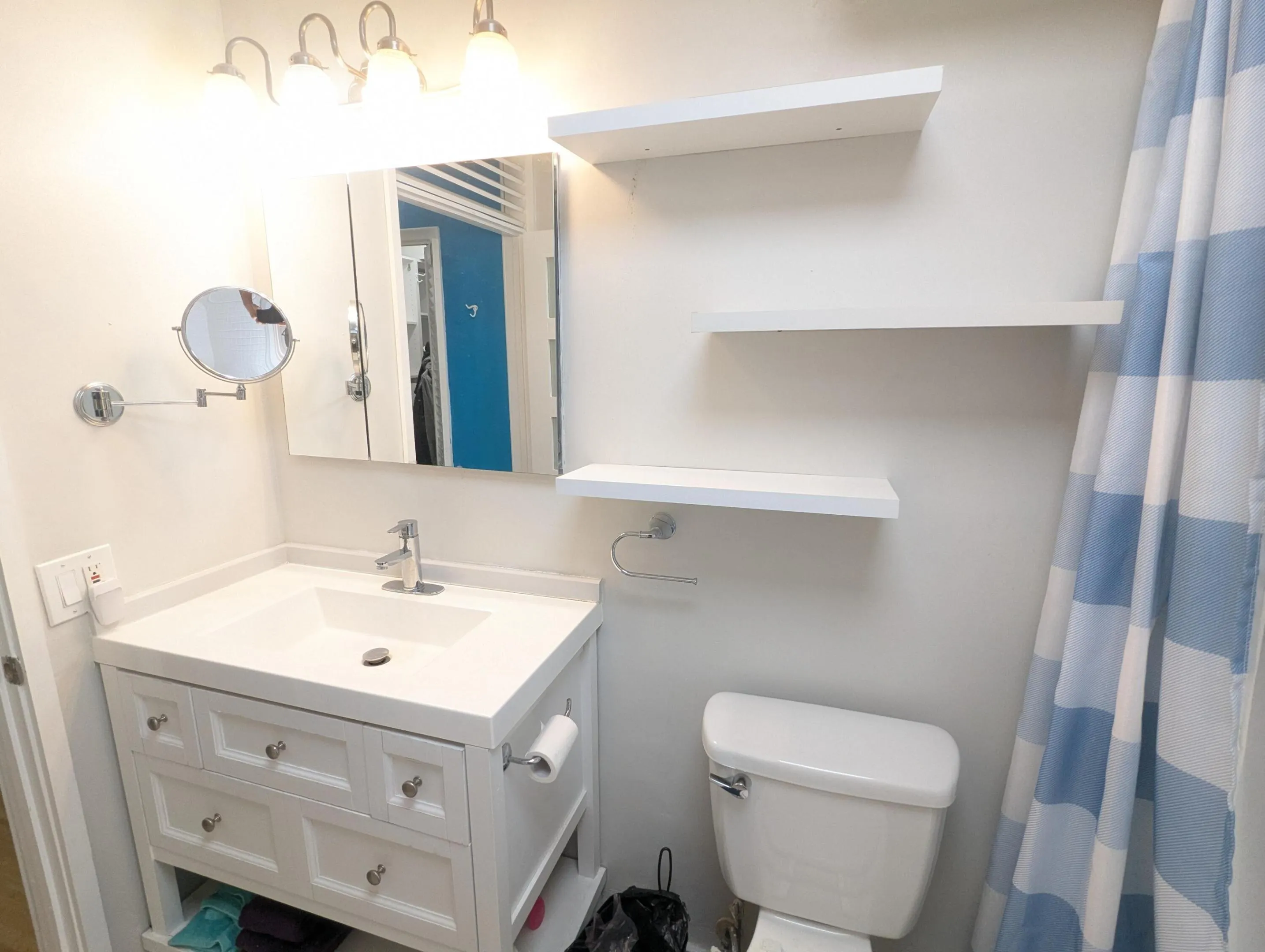 Main bath, white vanity with integrated sink, chrome faucet, and storage drawers