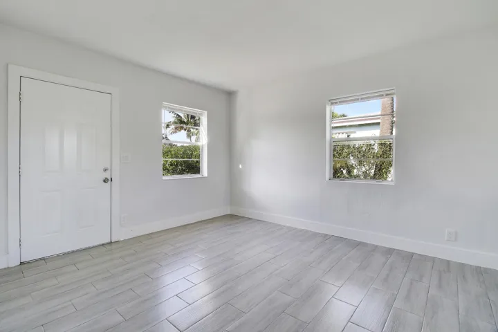Crisp white walls, two windows providing natural illumination,