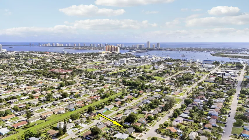 Aerial perspective of a residential neighborhood with distant coastal waters
