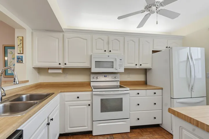 White cabinets and newer white appliances.