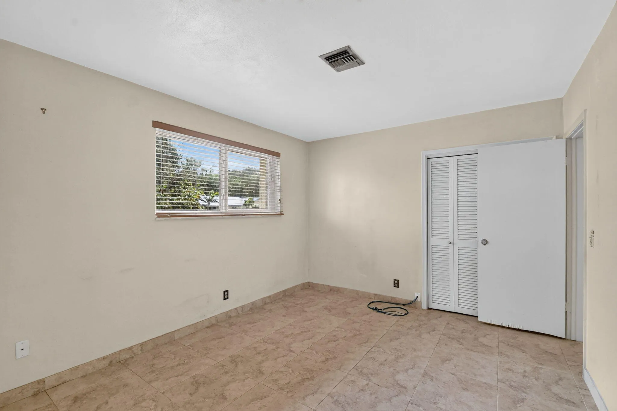 Neutral-toned walls complement the tile flooring
