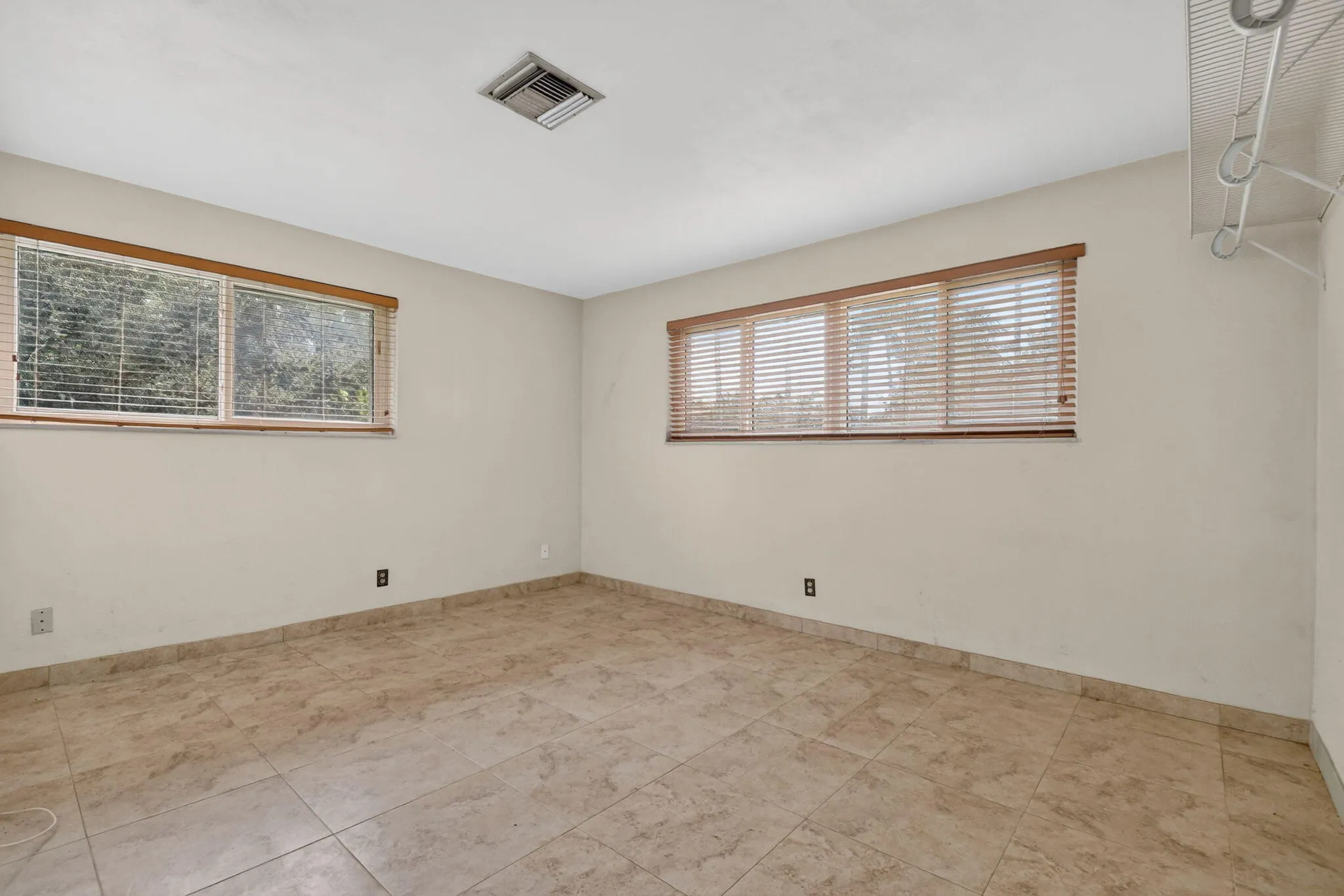 Tile flooring throughout, ample natural light from multiple windows, and a built-in closet organization system