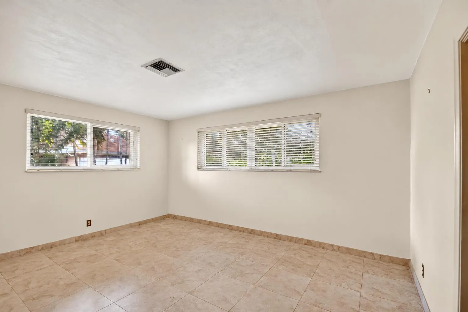 Empty Sunlit Room with Horizontal Blinds