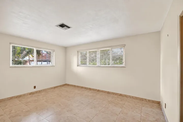 Empty Sunlit Room with Horizontal Blinds