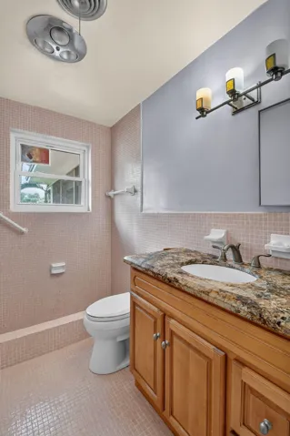 Vanity with stone countertop and undermount sink