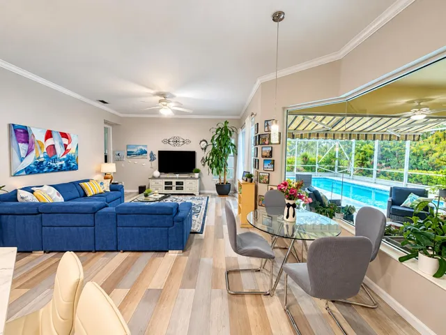 Breakfast nook and family room lined with glass to view outdoor beauty.