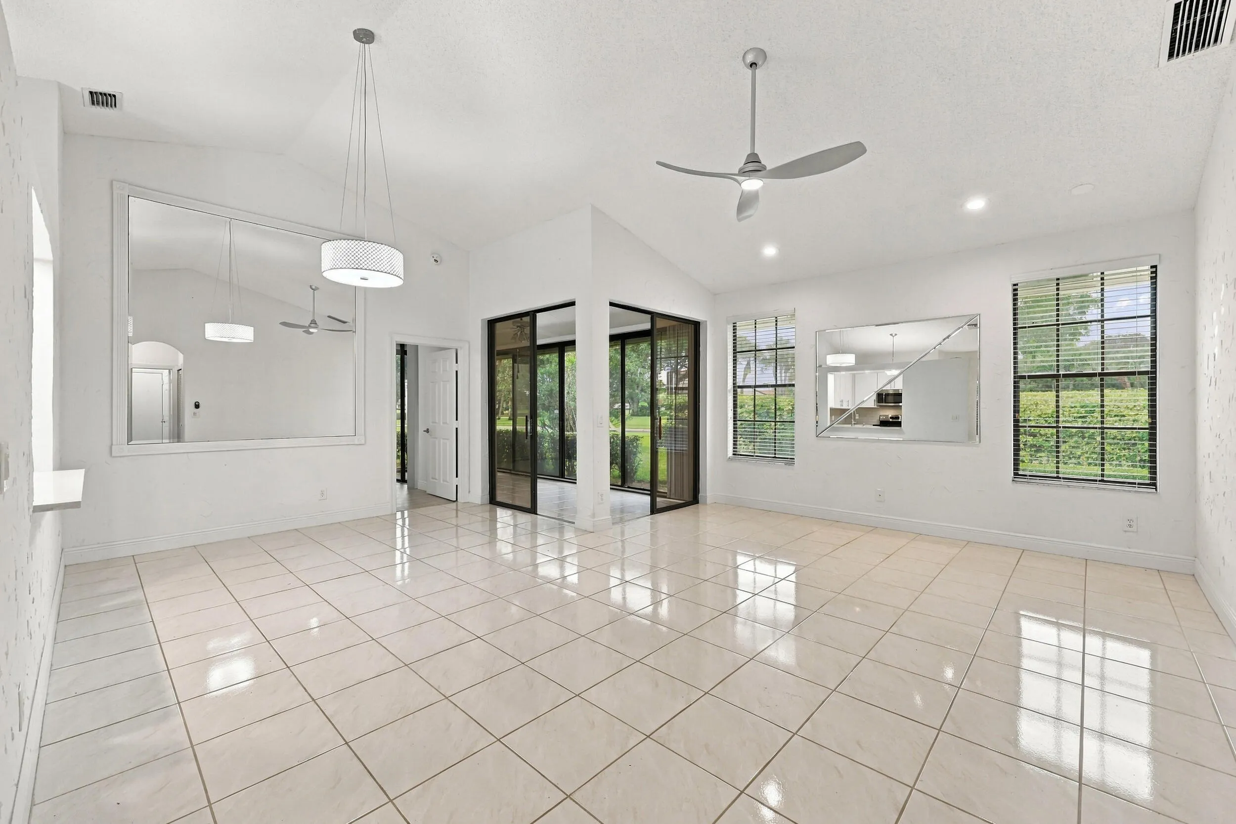 Vaulted ceilings, recessed lighting, and tile flooring