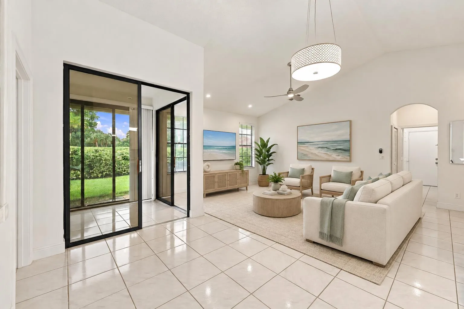 Vaulted ceiling, recessed lighting, ceiling fan, arched doorway, and tiled flooring