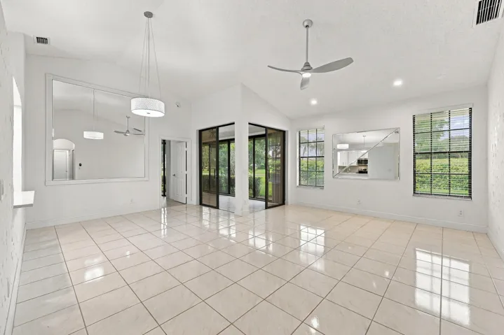Vaulted ceilings, recessed lighting, and tile flooring