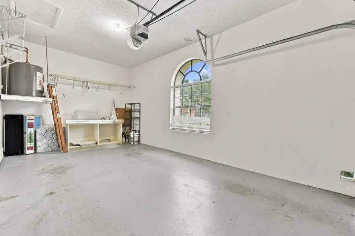 Garage featuring a light gray concrete floor and a transom window