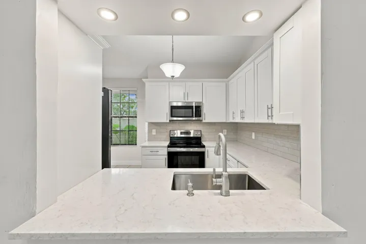 Breakfast bar with a large stainless steel sink and a single-handle faucet