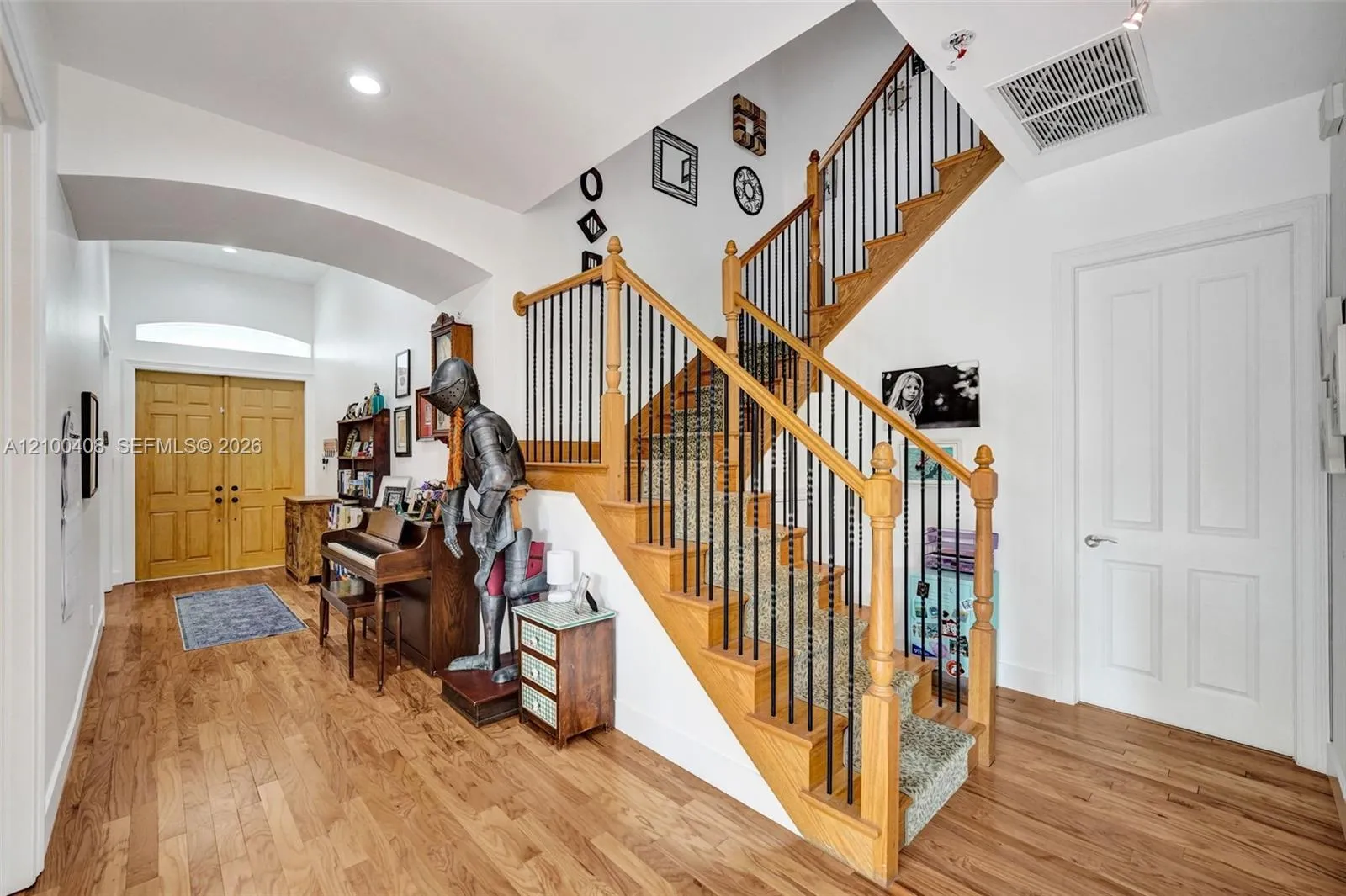 Wood floors carry up the stairwell.