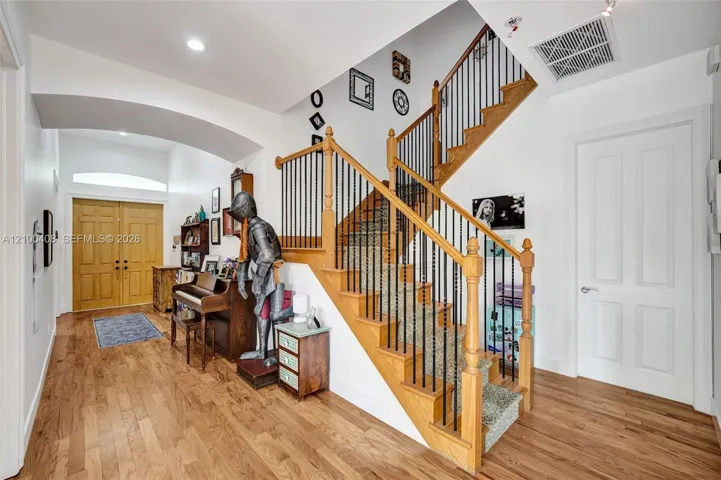 Wood floors carry up the stairwell.
