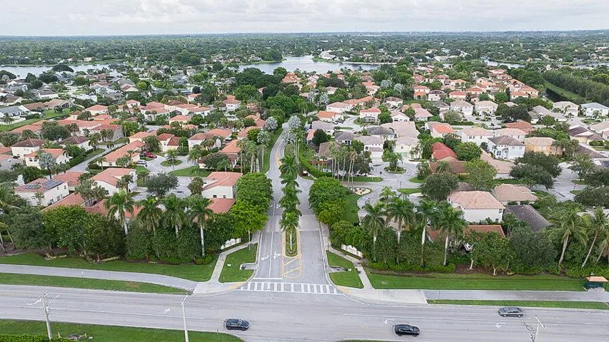Residential community with mature tree-lined streets and water features
