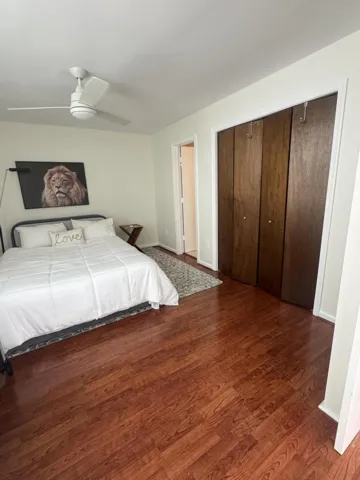 Rich wood-finish flooring complements the neutral wall tones