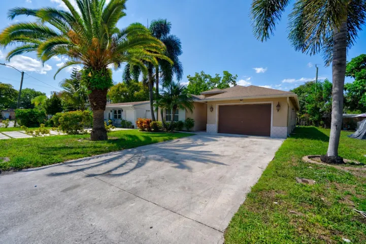 Concrete driveway leading to a single-car garage
