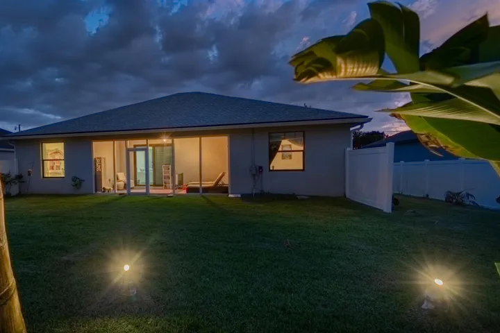 Expansive grass lawn featuring two ground-mounted uplights