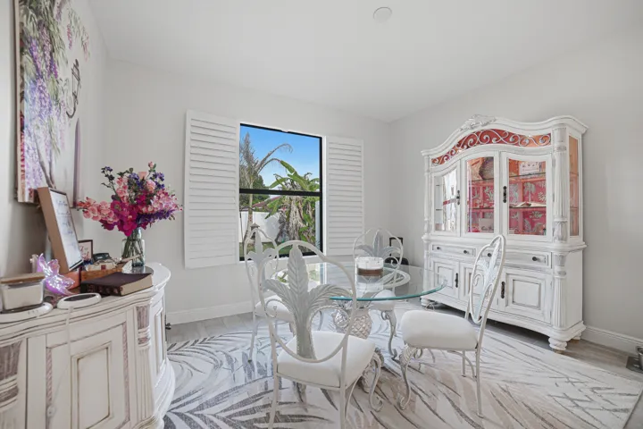 Recessed lighting, wood-finish flooring, and window with plantation shutters