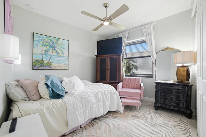 Light gray wall paint, window with blinds, ceiling fan, and wood-finish flooring