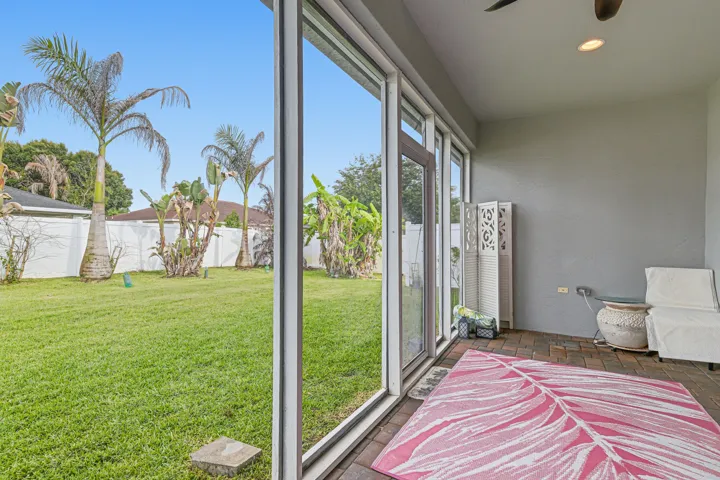 Screened-in patio with brick-finish flooring