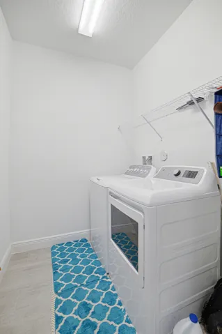 White interior walls with a wire shelving system and overhead fluorescent lighting