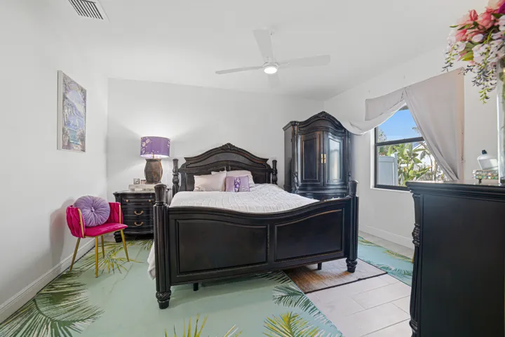 Recessed lighting, ceiling fan, window with exterior foliage, and white wall finishes