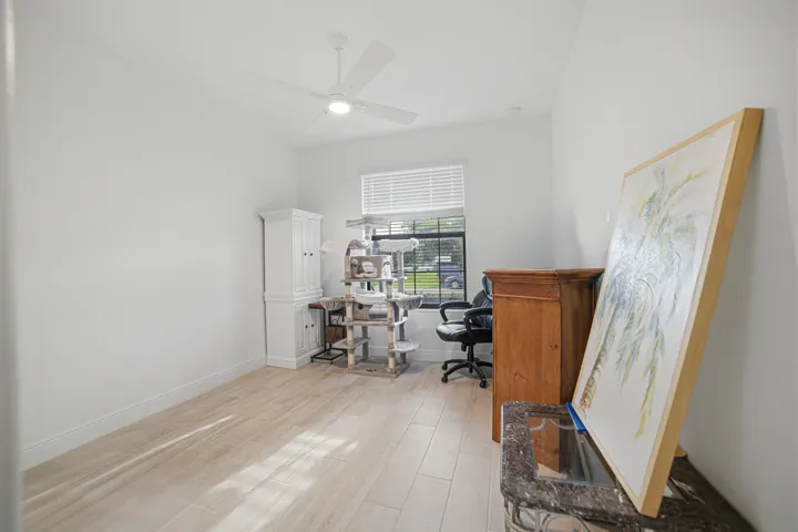 Recessed lighting, wood-finish flooring, ceiling fan, window with blinds, and white painted walls