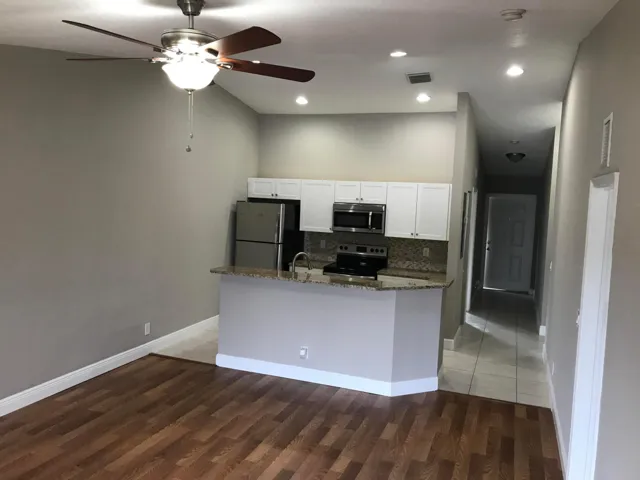 Wood-finish flooring, recessed lighting, and a ceiling fan
