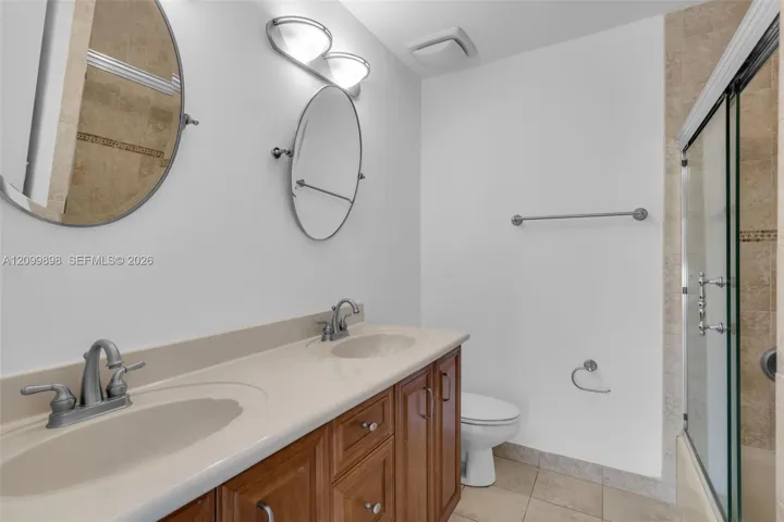 The Primary Bathroom has an en-suite Bathroom that has dbl vanity sinks, new mirrors and lights.