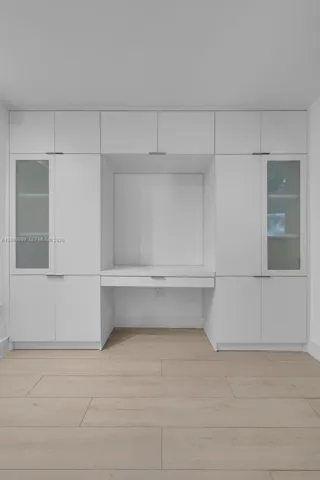 Look how nice the glass doors look on either side of the built-in computer desk/entertainment center and how much hidden storage one has in this built-in cabinet!