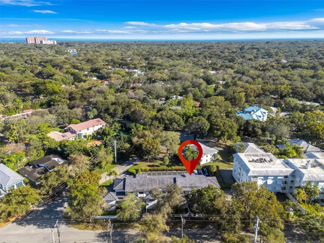Looking South-East, this view shows the "Gables South Condo Building" and that exact location of Unit 206 and that the Primary Bedroom faces South-East which overlooks a quiet residential family neighborhood! The dark blue you see over the tree line is Biscayne Bay and Matheson Hammock Beach, that is a wonderful Beach & only a 2 mile BICYCLE RIDE" away from your Townhouse!!