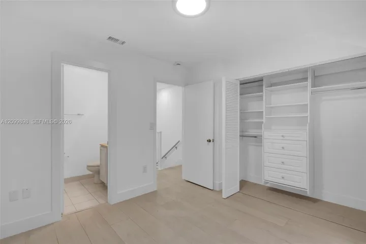The second Bedroom faces the North and and notice the built-in closet organizers & in the next picture you will see that their is a small balcony facing North. The left door is the en-suite bathroom with a tub.