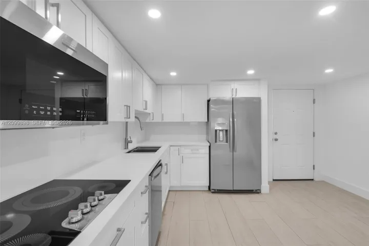 Another view of the kitchen and the foyer entrance with the Impact front door and all the windows and sliding glass doors are Impact as well! The whole building had all the windows and doors done by the Association so that everyone has Impact Windows/Doors and the product is the SAME for all units! Very Smart, wouldn't you say?