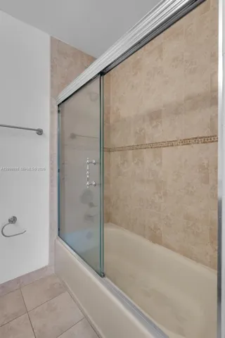 The 2nd Bedroom en-suite Bathroom has a nice tub and nice glass doors.
