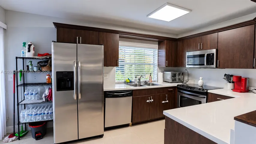 Bright kitchen with a window over the sink and plenty of counter and cabinet space.
