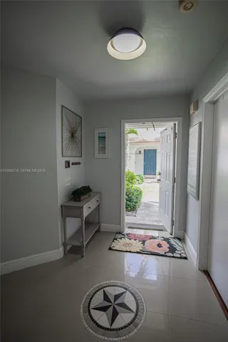 Bright entry hall with tile floors and natural light leading into the main living space.