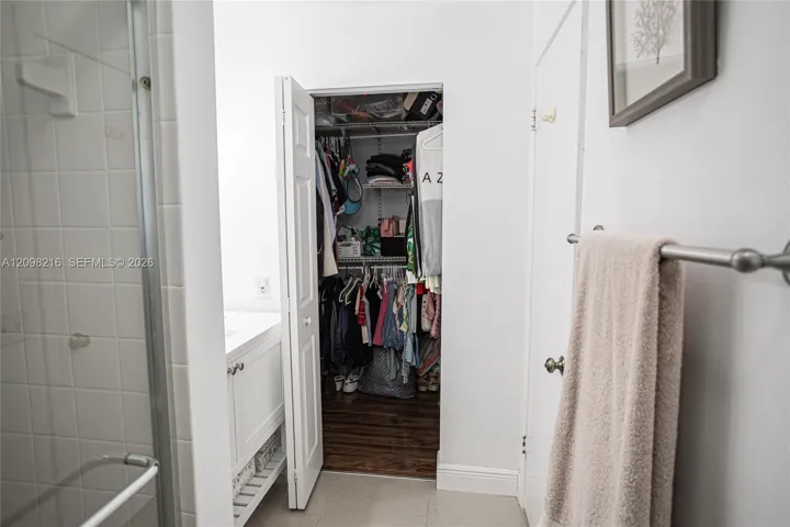 Bathroom with direct access to a walk-in closet.
