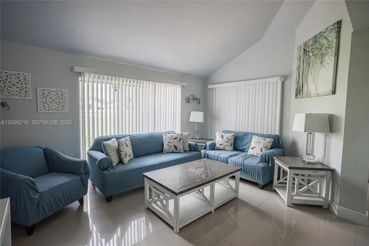 Spacious living room with high ceilings and generous room for seating.