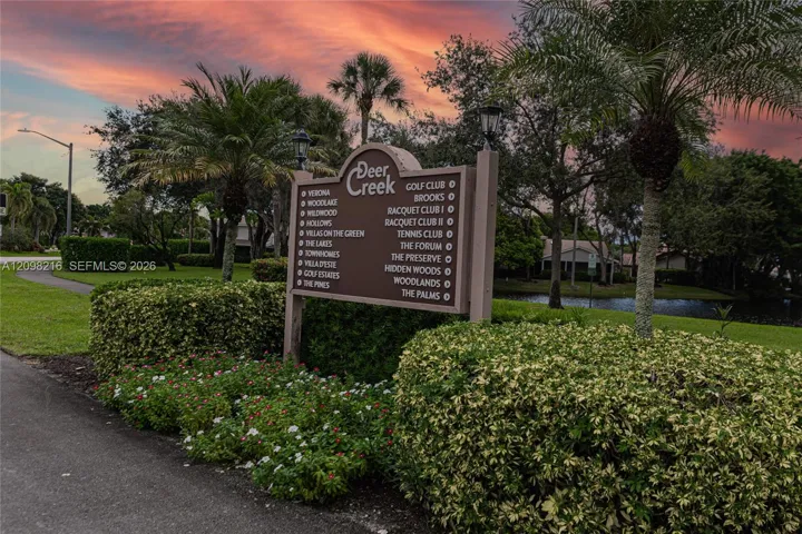 The community's entrance monument, framed by manicured landscaping.