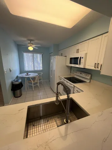 looking into the kitchen from the dining area pass-through