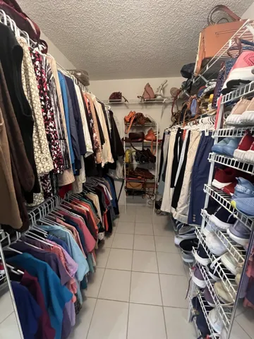 very deep walk-in closet in the primary bedroom