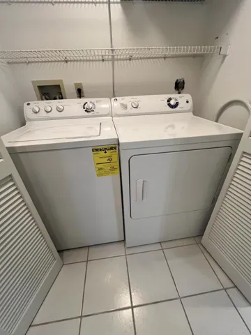 full sized side by side washer/dryer in utility closet