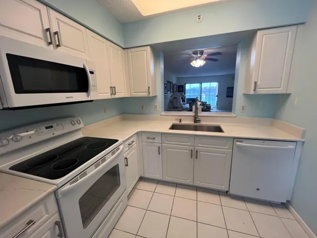 updated white shaker cabinets with all white appl.'s and a mounted microwave included.