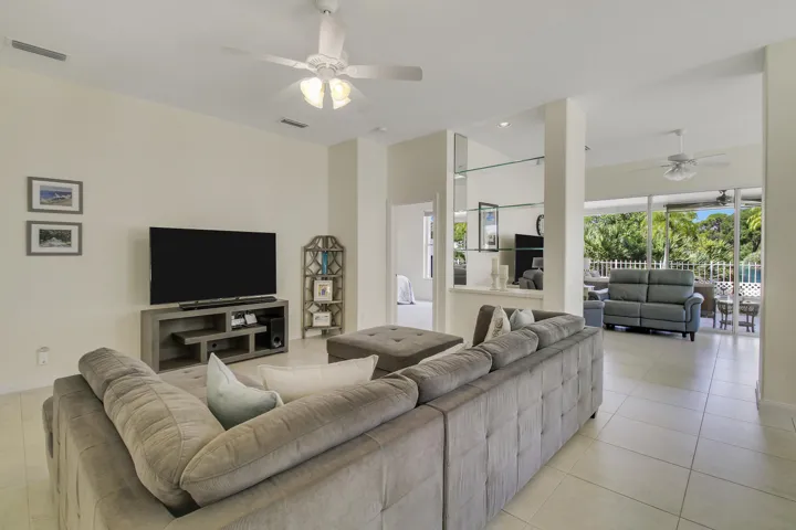 Recessed lighting, ceiling fans, tile flooring, and glass shelving create bright, functional spaces.