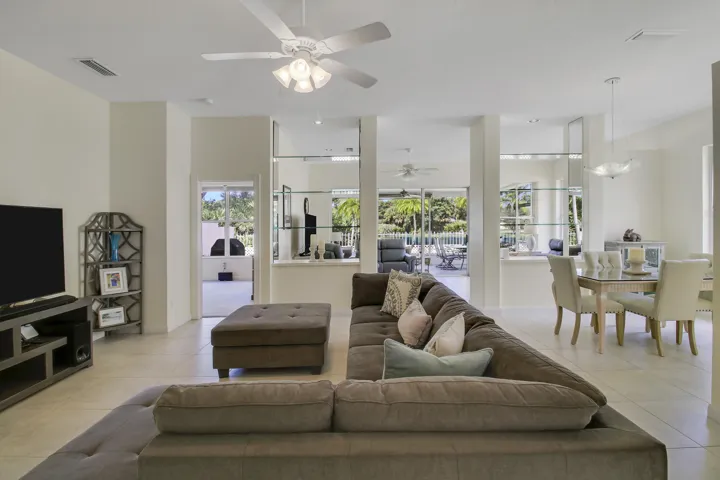 Open concept living area with tiled flooring, neutral wall tones, and recessed lighting