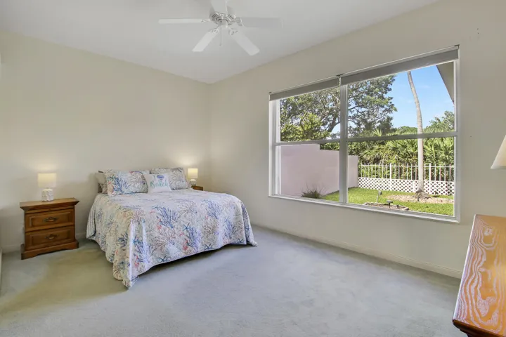 Primary Suite with large window overlooking backyard and lake